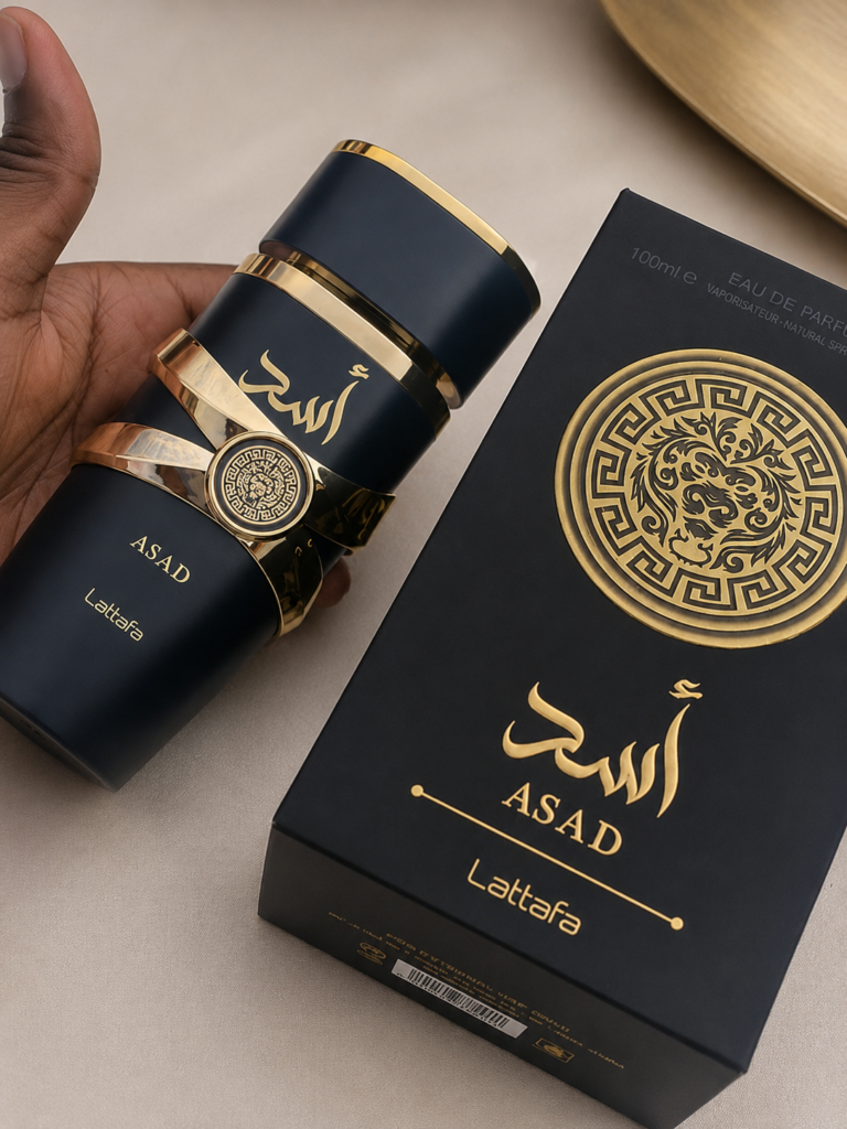 Lattafa Asad Eau de Parfum bottle and box on a clean luxury background, showcasing the men's woody spicy fragrance.